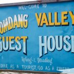 A signboard welcomes treks to warm food and accomodation avaiable during langtang valley trek - Langtang Valley Trek