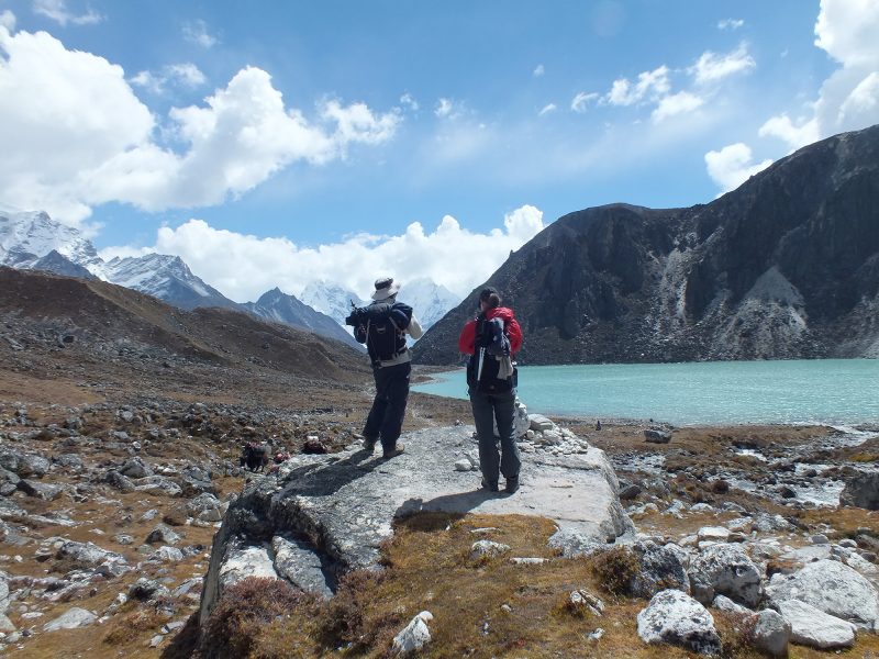 Trekkers enjyoing view of Gokyo Lake Everest region - Gokyo Lake with Everest Base Camp