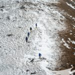Trekkers walking through the thin snow spreads during winter at Pikey Peak - Pikey Peak