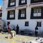 Devotees prostrate as a part of their prayer and offering in Tibet - Lhasa Kathmandu Overland Tour