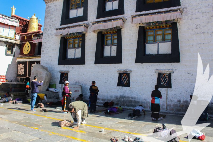 Devotees prostrate as a part of their prayer and offering in Tibet - Lhasa Kathmandu Overland Tour