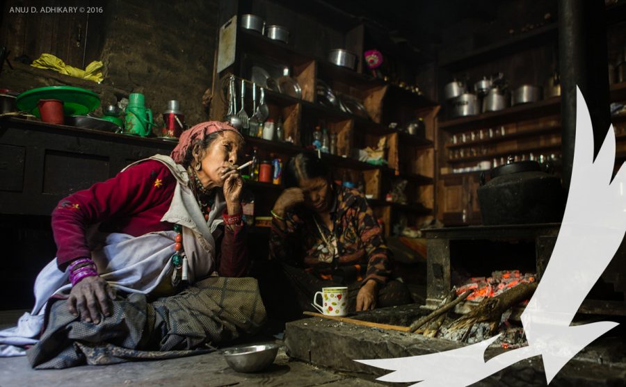 Smoking a cigarette in a traditional house in Chhepka Dolpo - Upper Dolpo With Bardia National Park